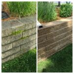Power washing moss and dirt off of landscaping block with grass and ornamental glass seedums mulch - Class Act Glass Best Window Cleaning Services in Mankato and Southern Minnesota