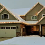 Holiday lights on a house and tree in white gold red blue green multicolored three stall garage in winter during the day - Class Act Glass Best Window Cleaning Services in Mankato and Southern Minnesota