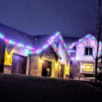 Colorful red blue green purple pink holiday lights on a home at night - Class Act Glass Best Window Cleaning Services in Mankato and Southern Minnesota