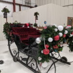 Holiday sled decorated for Christmas with white red silver balls and garlands santa hat holiday decorating - Class Act Glass Best Window Cleaning Services in Mankato and Southern Minnesota
