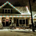 Holiday lights in red green and white on a house in winter with snow at night - Class Act Glass Best Window Cleaning Services in Mankato and Southern Minnesota